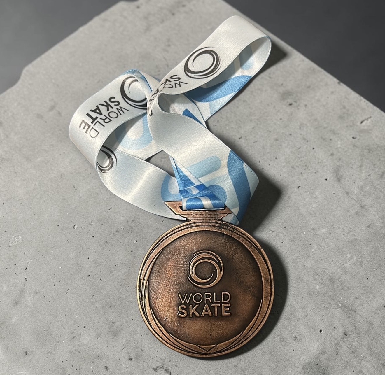 Reverse view of the completed World Skate medal showing the event mark and dimensional metal surface